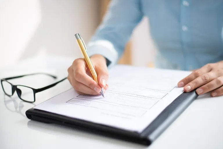 Businesswoman making notes on a document