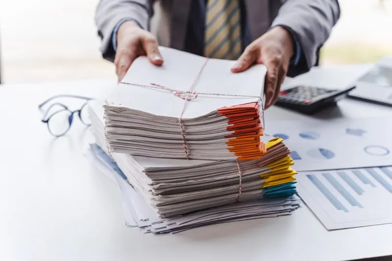 Piles of documents on an office desk