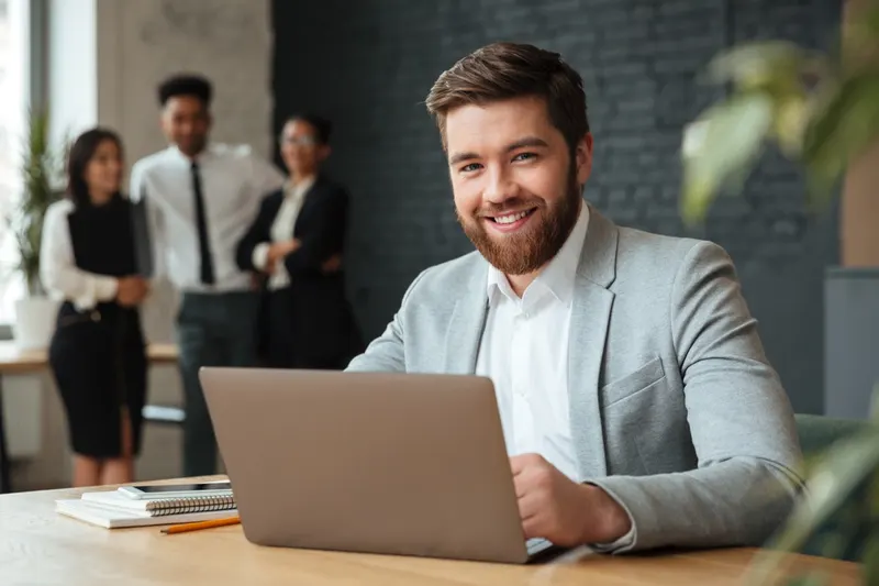 Cheerful young businessman reviewing invoice approvals