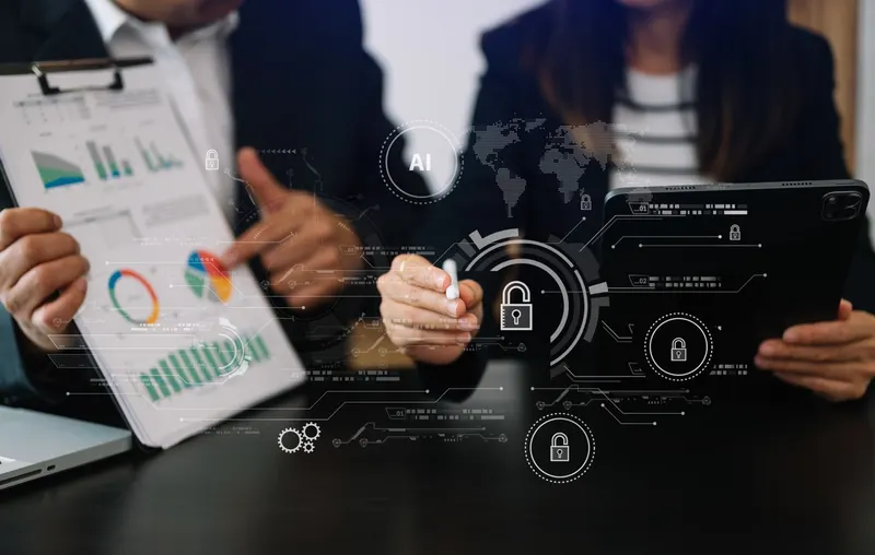 Business user with a tablet and computer behind a digital padlock, representing data protection and cyber security