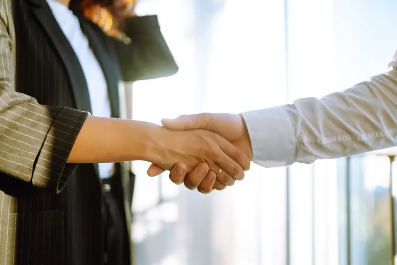 Close-up of business people shaking hands after a contract meeting