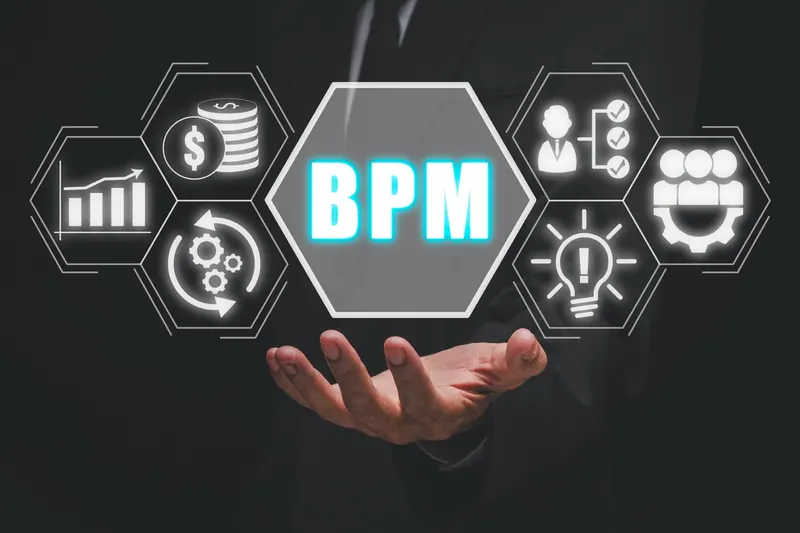Business process management concept: a hand holding a BPM icon on a virtual screen