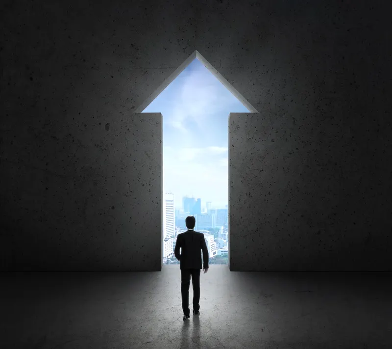 Businessman standing in front of a bright open door, a new approach beyond ERP