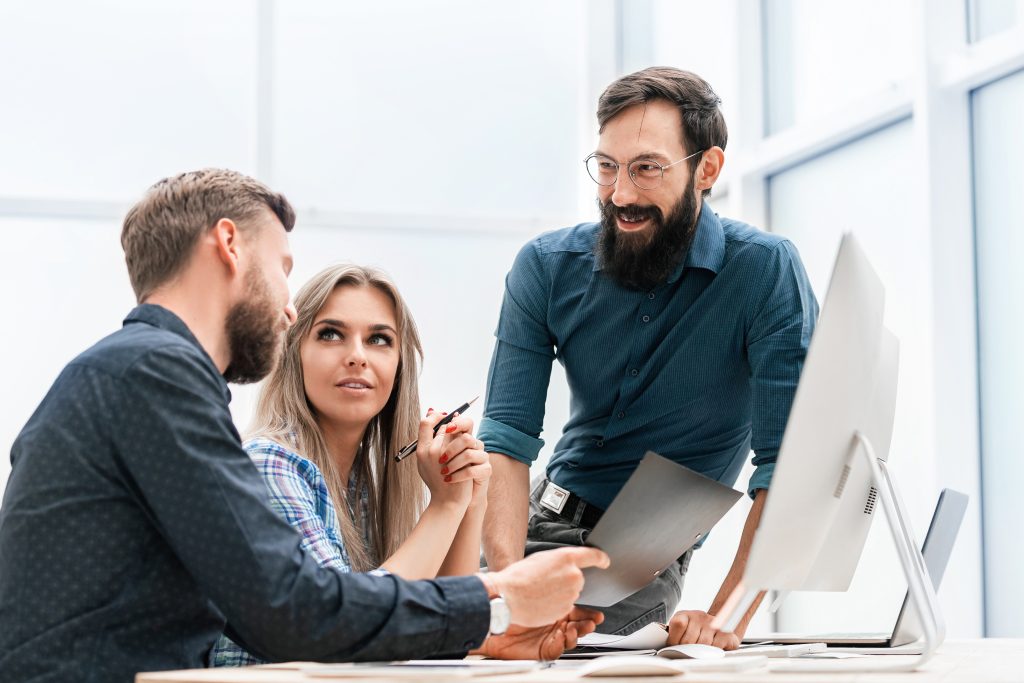 Young woman discussing business matters with her colleagues